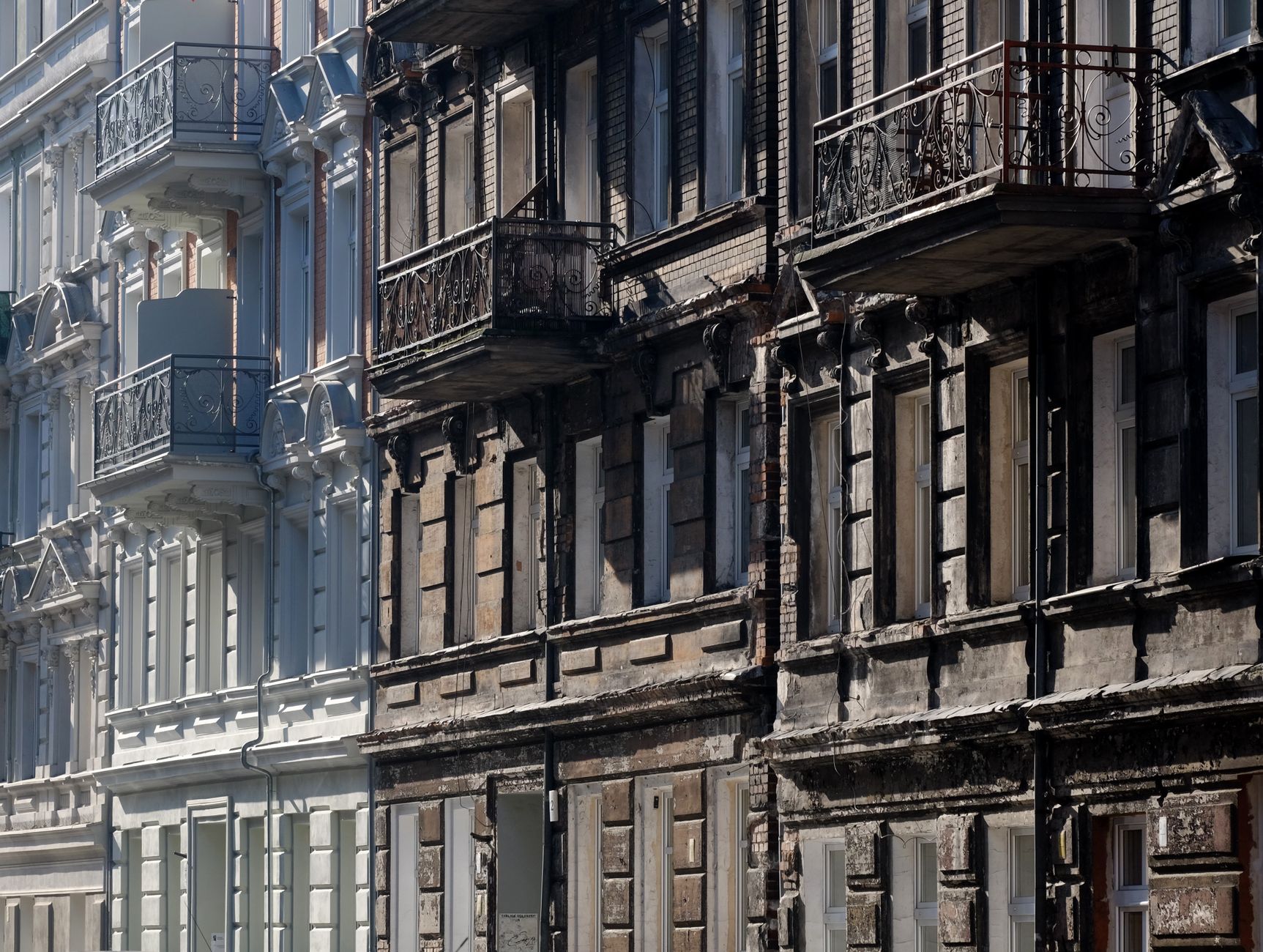 Side-by-side comparison of renovated and old apartment building facades with balconies.