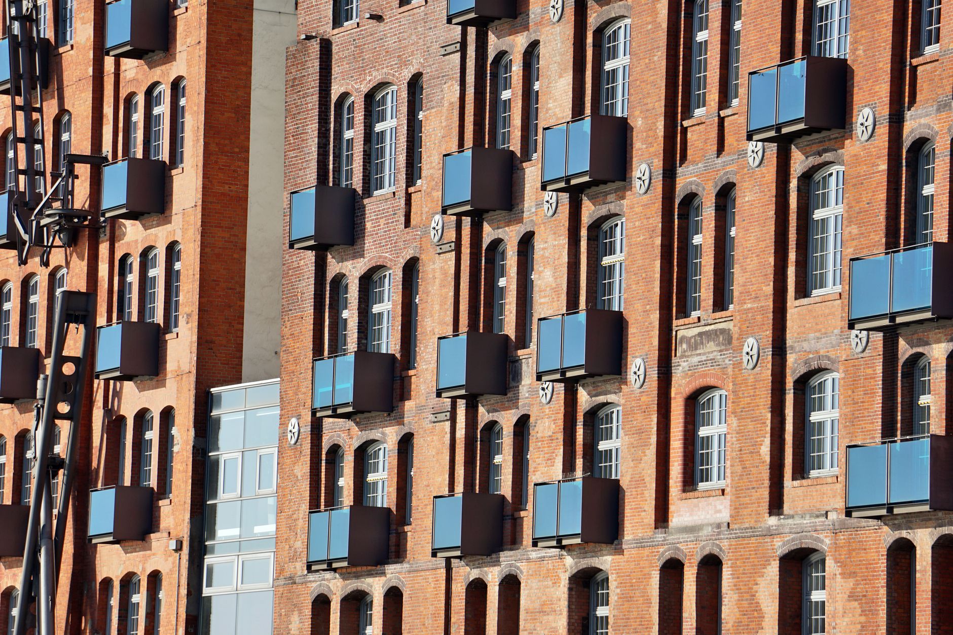 A blend of historic brick architecture and modern balconies in Hamburg, Germany.