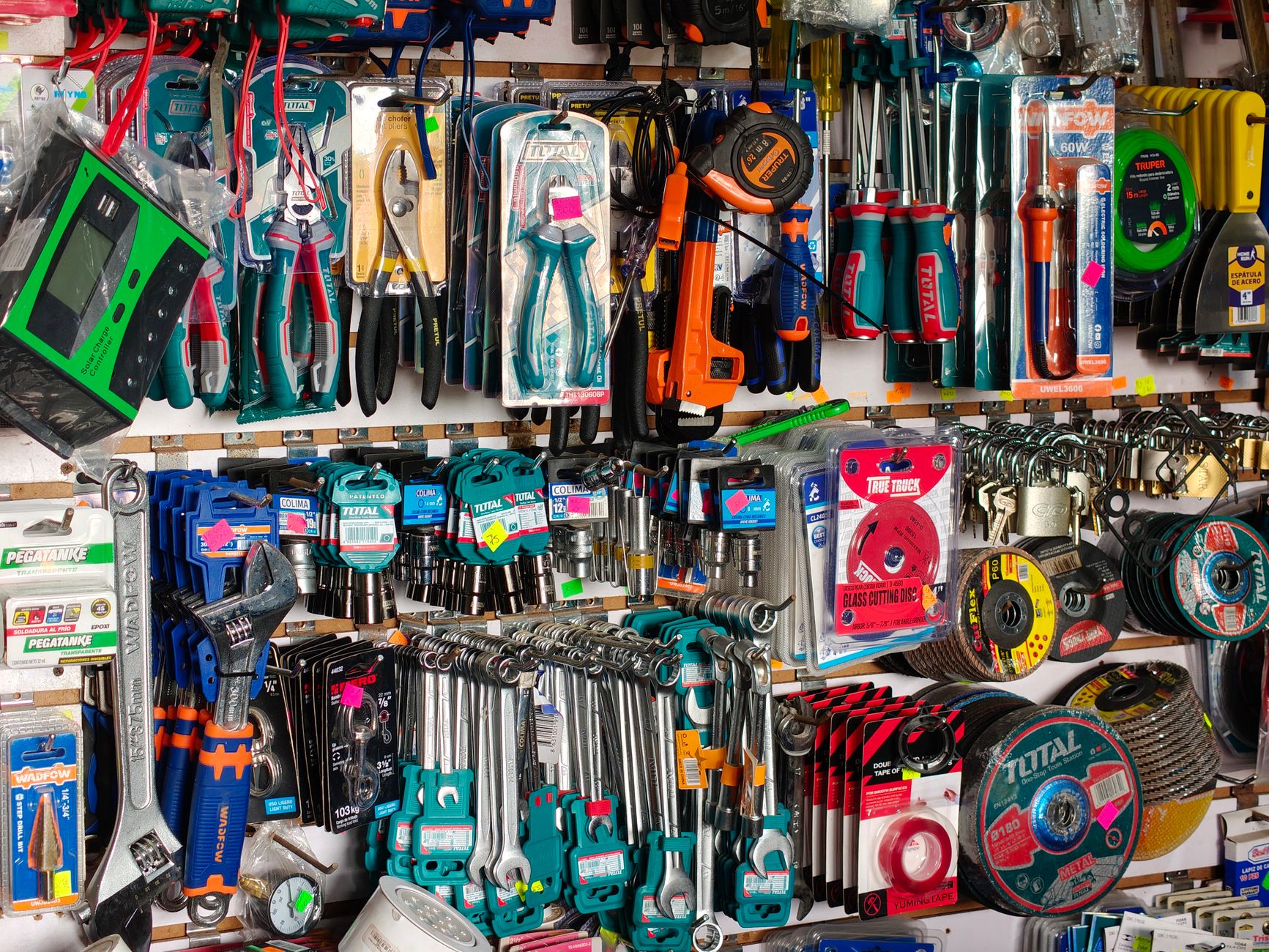 A comprehensive display of diverse hardware tools including pliers, screwdrivers, and wrenches in a store.