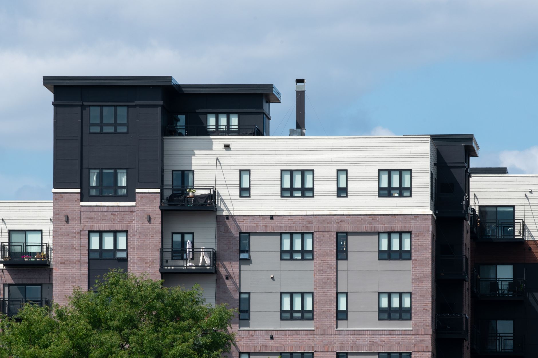 Contemporary apartment complex showcasing diverse architectural styles and multiple balconies.