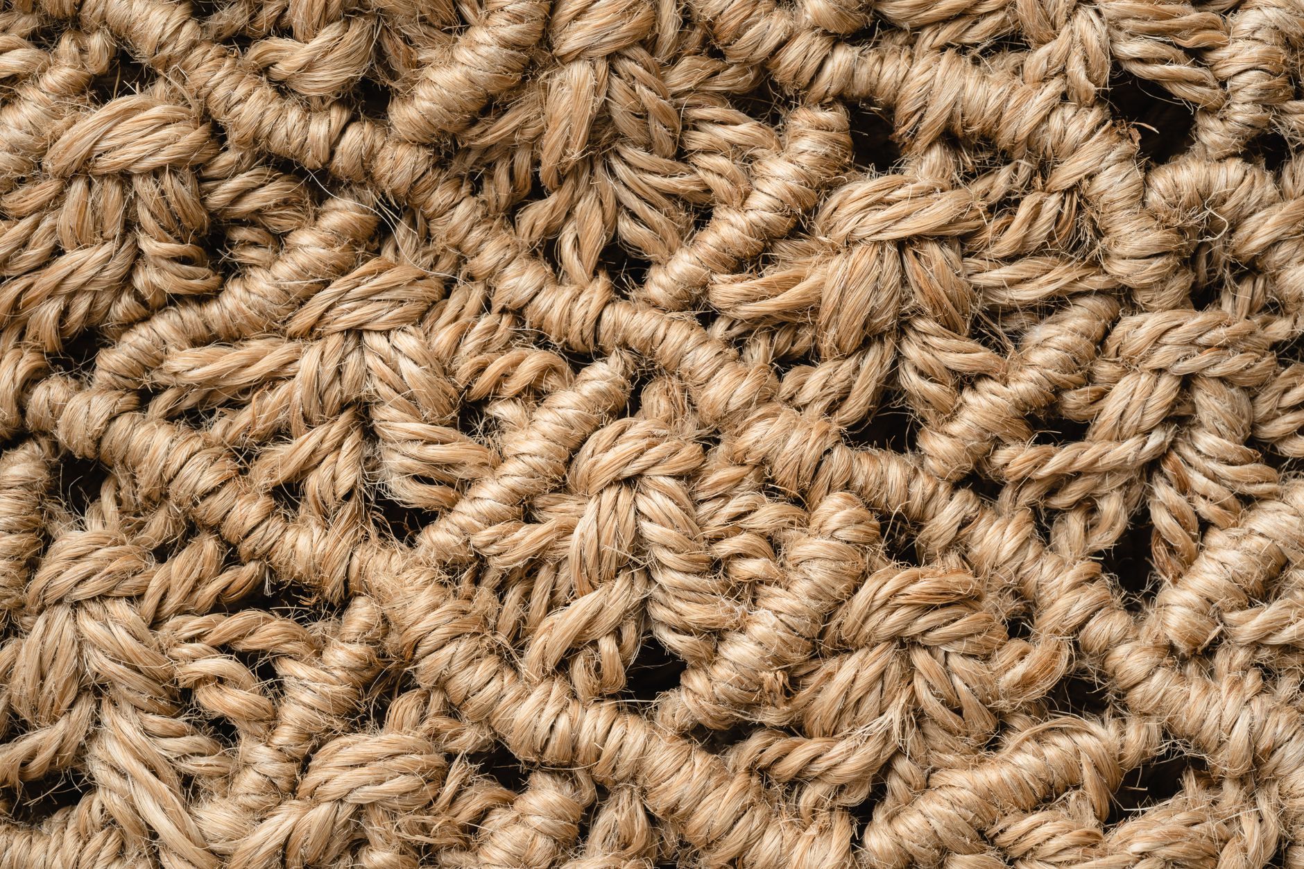 Detailed close-up of a handmade woven jute rope texture showcasing intricate patterns.
