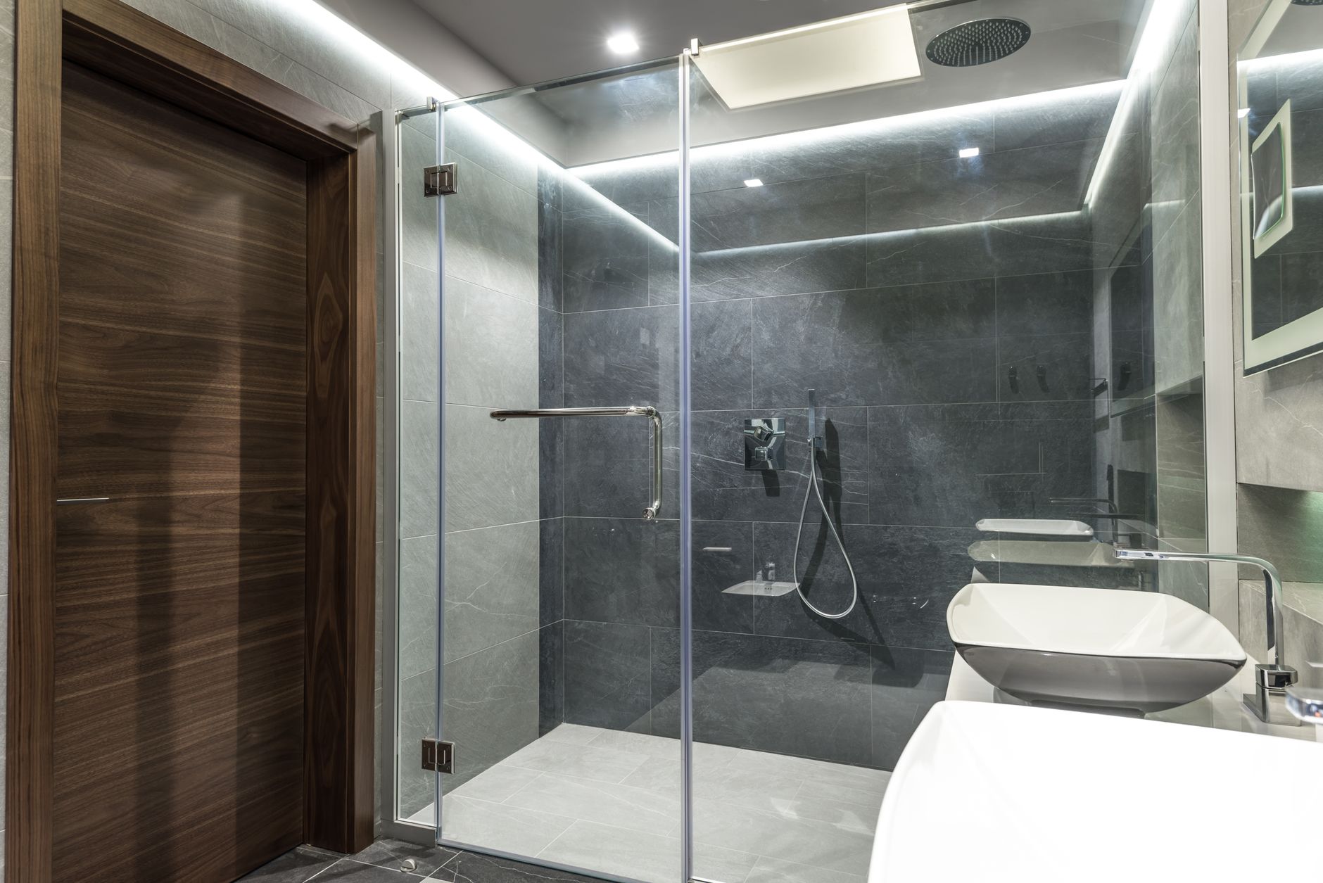 Modern minimalist bathroom featuring a spacious glass shower and sleek interior design.