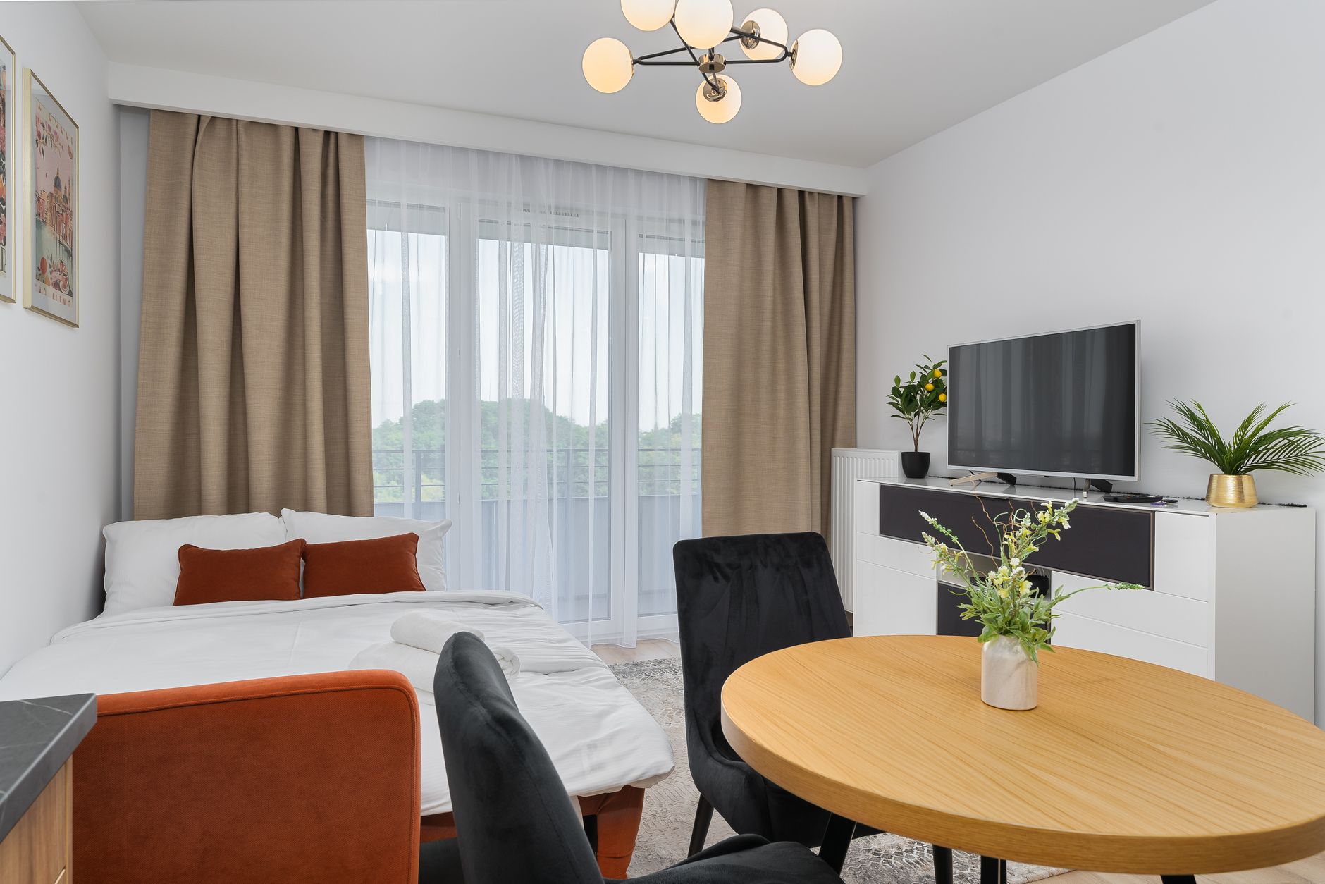 A bright modern studio apartment features a cozy living area with elegant decor.