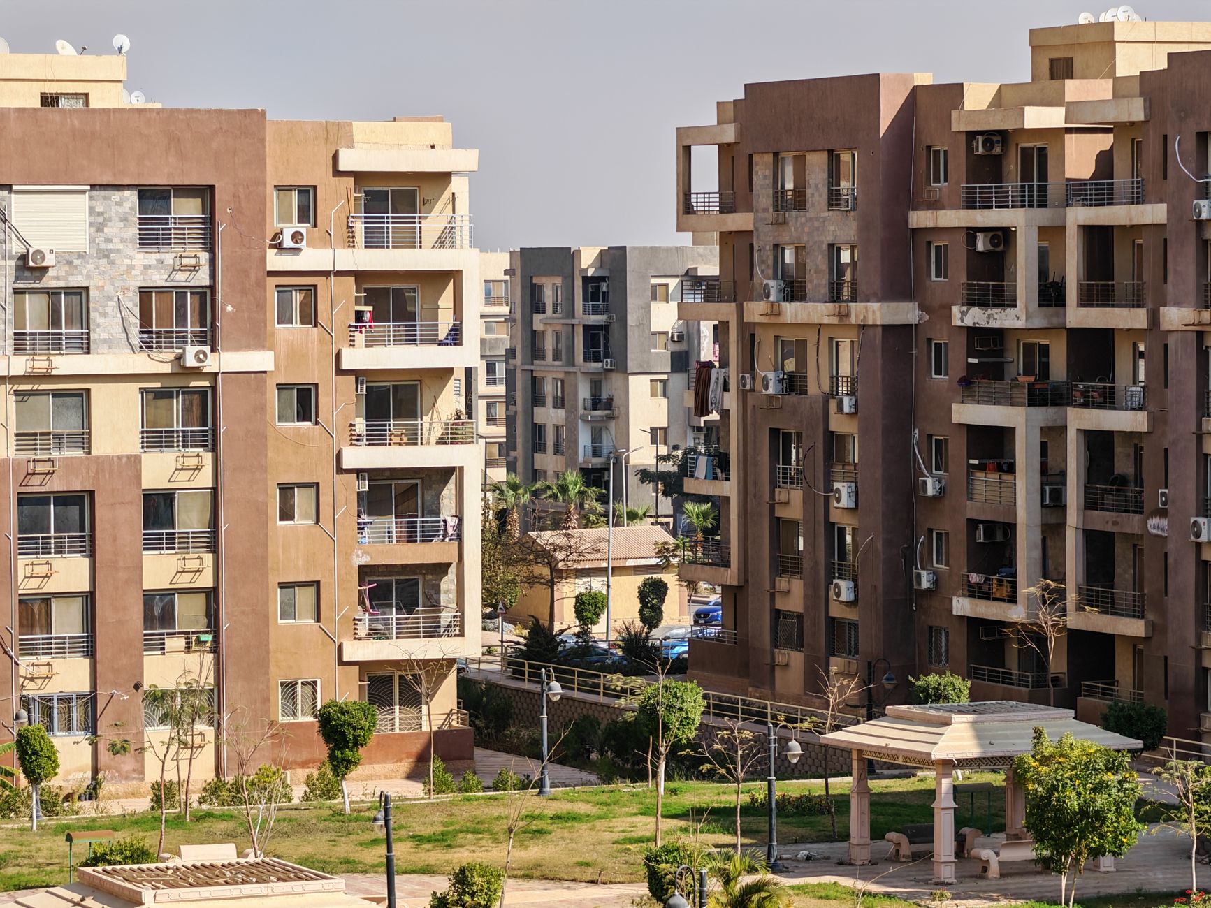 Contemporary apartment buildings with balconies and green spaces captured in daylight.