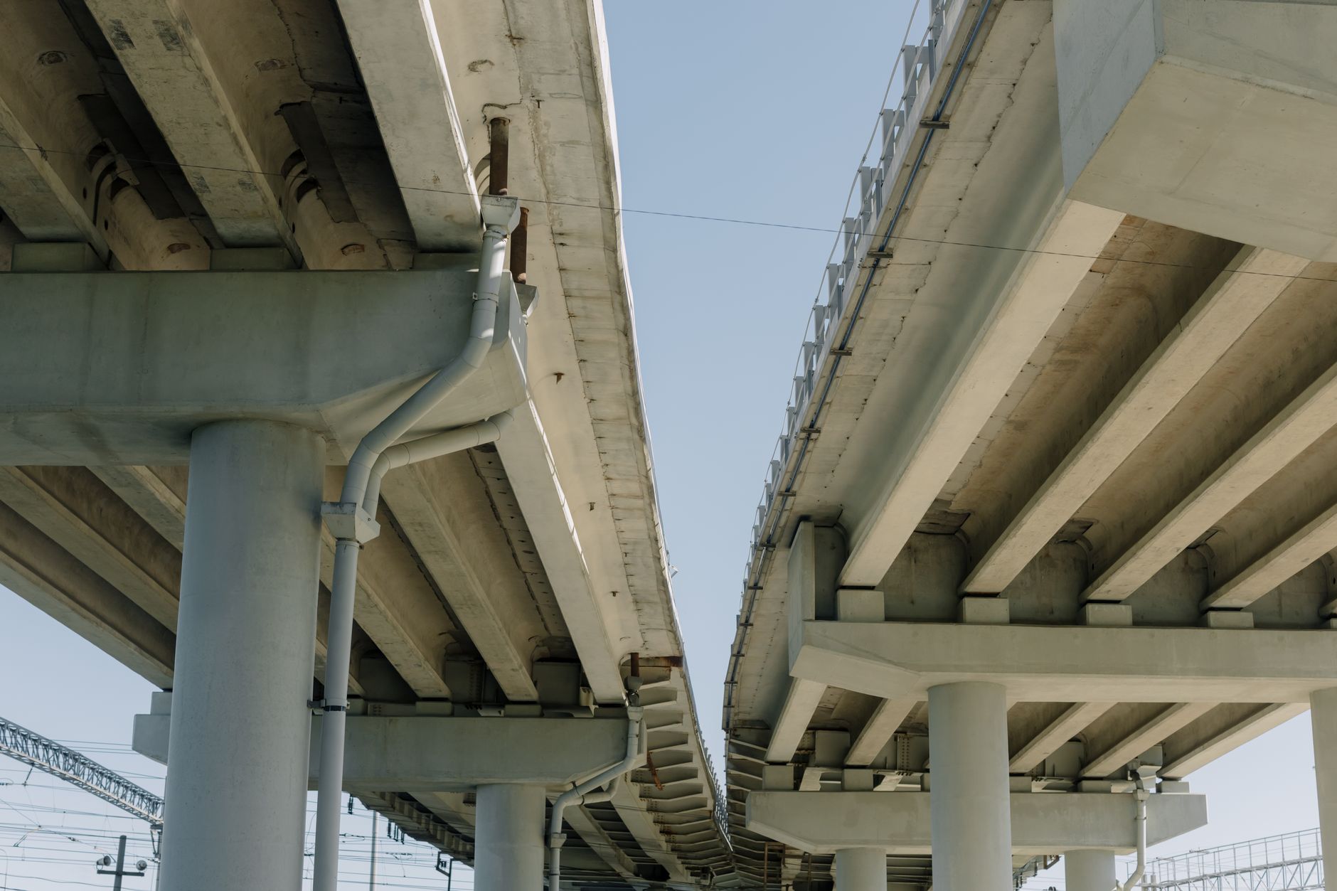 Concrete roadway overpass and pillars with clear blue sky background