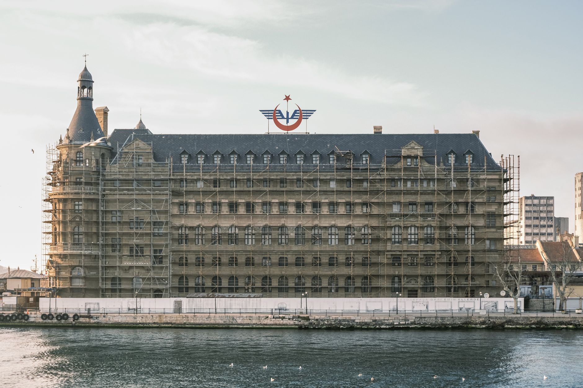 Scaffolding on a historic waterfront building under renovation.