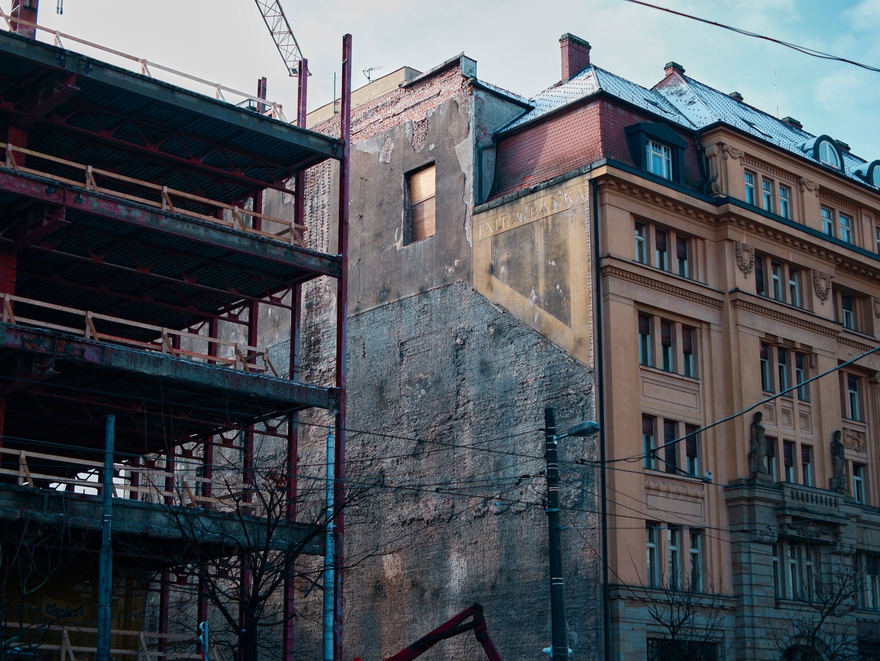 Architectural winter scene capturing construction scaffolding and historic buildings in Bratislava.